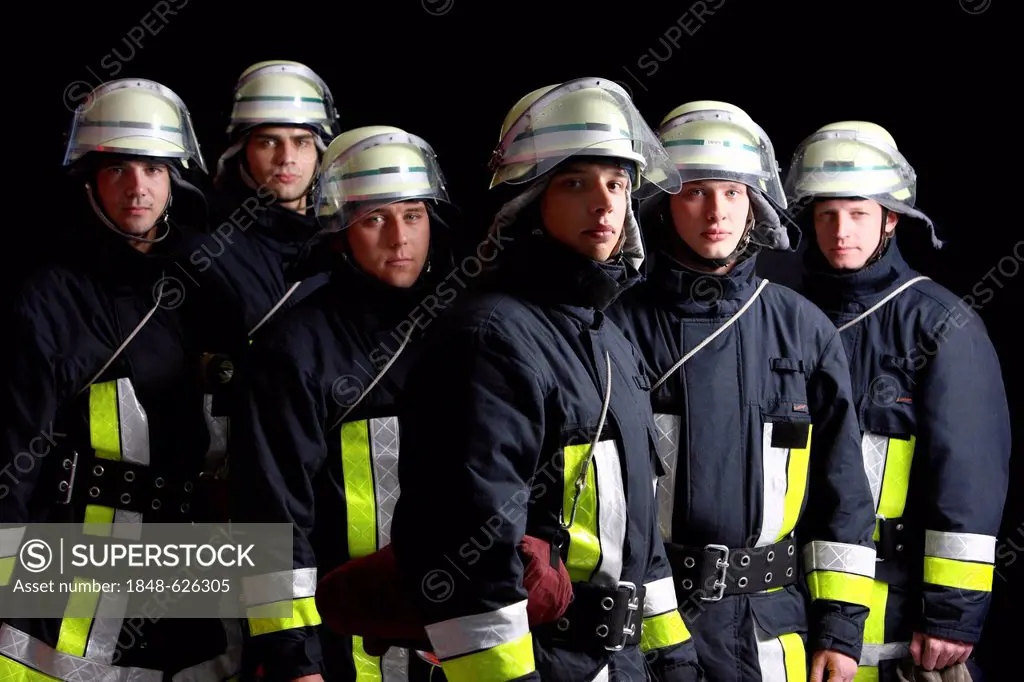 Firefighters wearing their uniforms for a response, protective clothing made of Nomex, a helmet with a visor, professional firefighters from the Beruf...