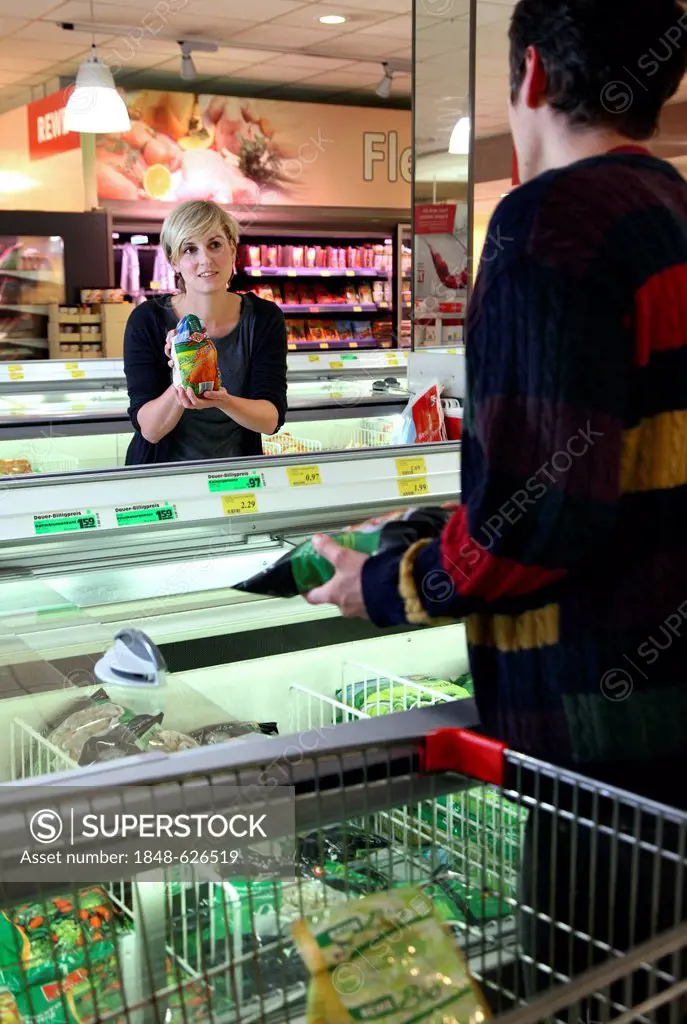 Customers standing in front of the deep freezers, frozen food, food hall, supermarket, Germany, Europe