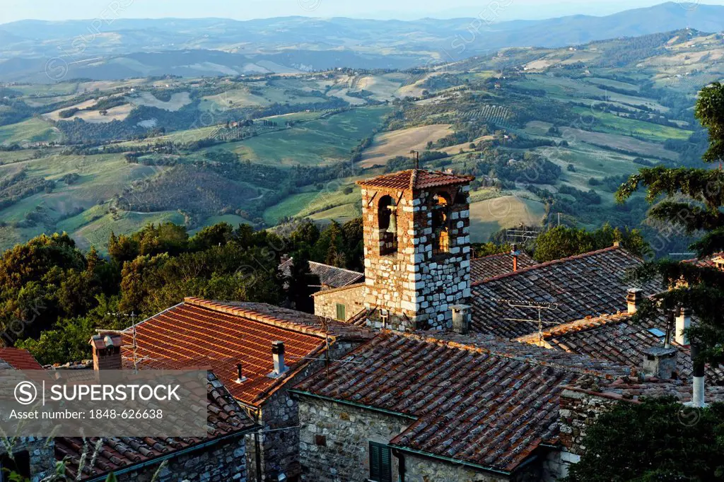 Old Bell tower above village roof tops in Tuscanian landscape, Libbiano, Tuscany, Italy, Europe