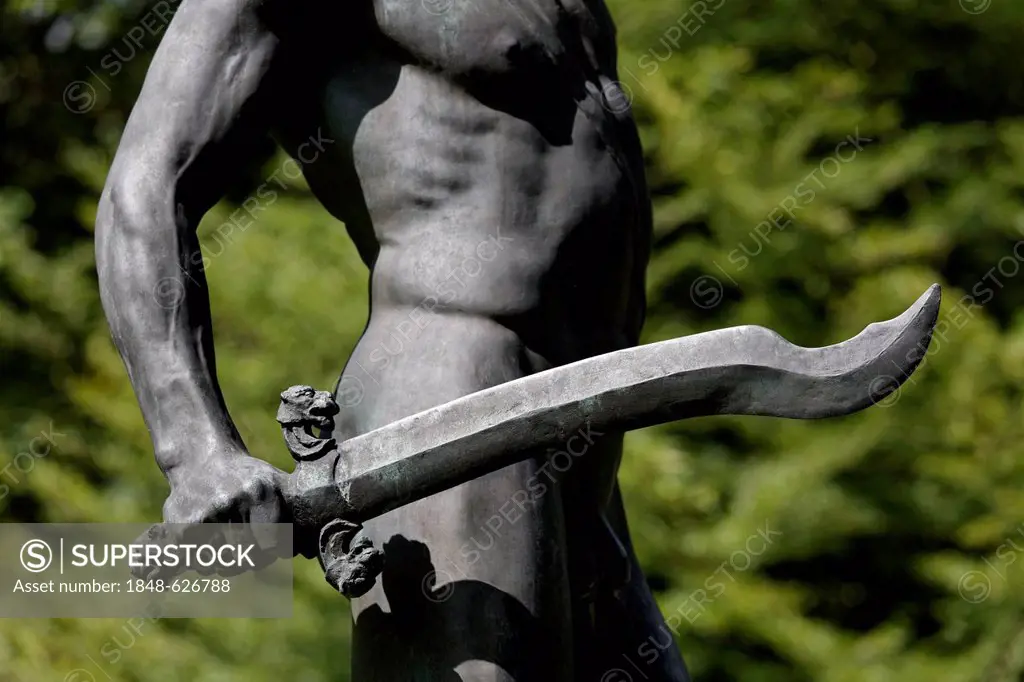 Naked man holding a sword, Perseus, bronze sculpture, Lantz'scher Park, Duesseldorf-Lohausen, North Rhine-Westphalia, Germany, Europe