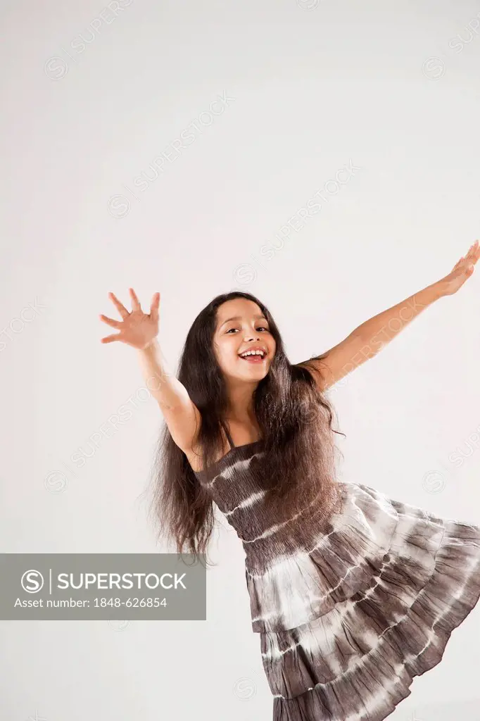 Girl dancing and stretching out her arms
