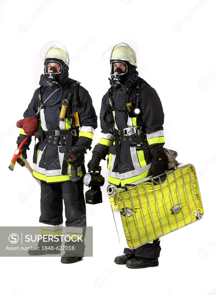 Firefighters, response squad for fire fighting, wearing protective clothing made of Nomex, a helmet with a visor, a fire axe, respiratory protective e...