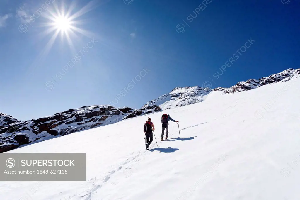 Hikers during the ascent to the peak of Hintere Eggenspitz mountain in the Ulten Valley above lake Gruensee, on Weissbrunnferner mountain, peak of Hin...