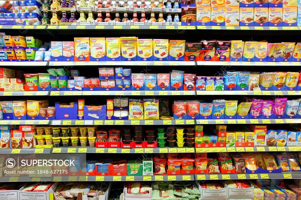 Shelves with a variety of products such as gelatine, rice pudding, custard powders, self-service, food department, supermarket, Germany, Europe