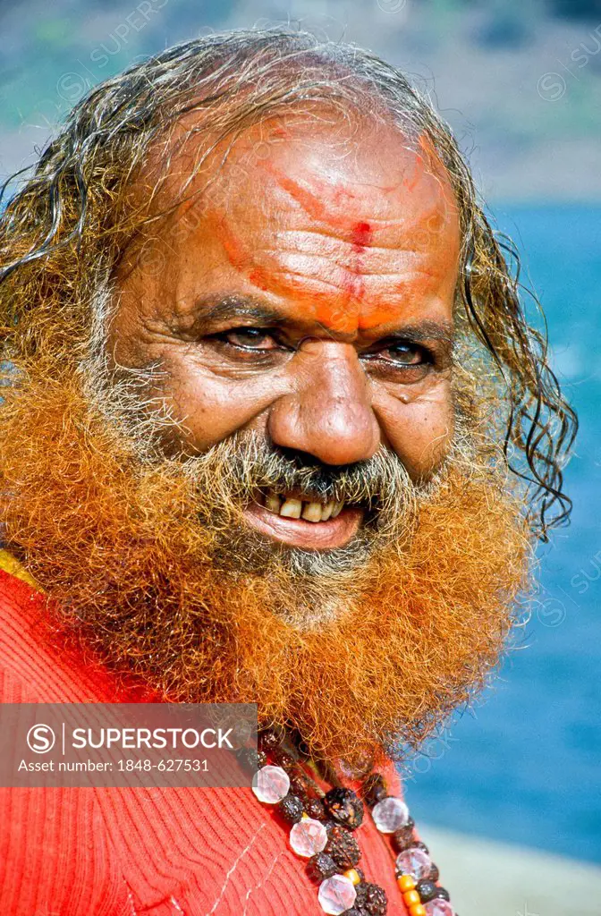 Portrait of a Sadhu, holy man, after his washing and praying ceremony in the morning at the holy Narmada river, Omkareshwar, India, Asia