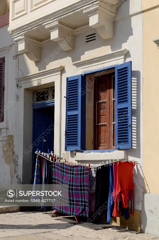 Laundry rack next to the entrance of a house, old town of Valletta, Malta, Europe