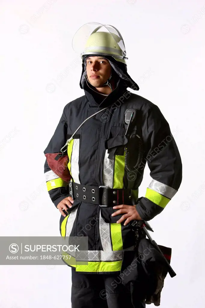 Firefighter wearing a uniform with basic equipment, protective clothing made of Nomex, a helmet with a visor, an equipment belt, a flashlight, a two-w...