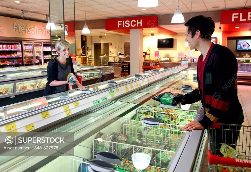 Customers standing in front of the deep freezers, frozen food, food hall, supermarket, Germany, Europe