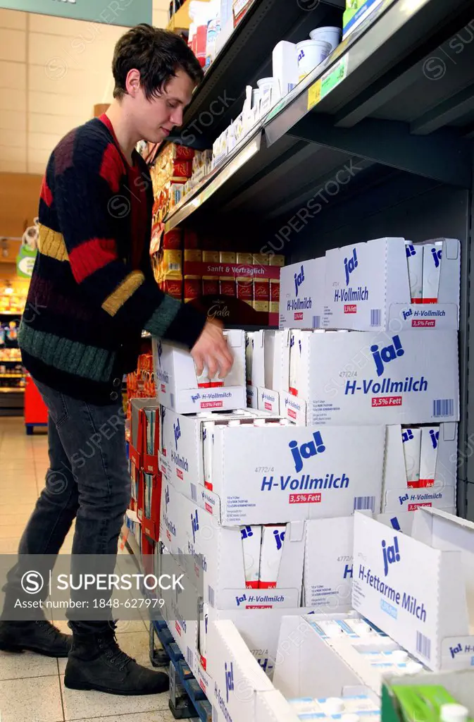 Man buying JA-brand long-life whole milk, food hall, supermarket, Germany, Europe