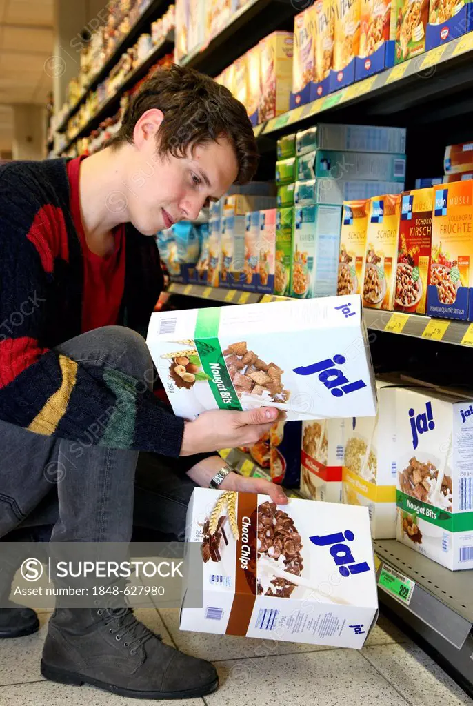 Man buying JA-brand Muesli, food hall, supermarket, Germany, Europe