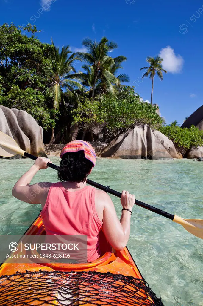 Woman in a kayak at Point Source d'Argent, La Digue Island, Seychelles, Africa, Indian Ocean