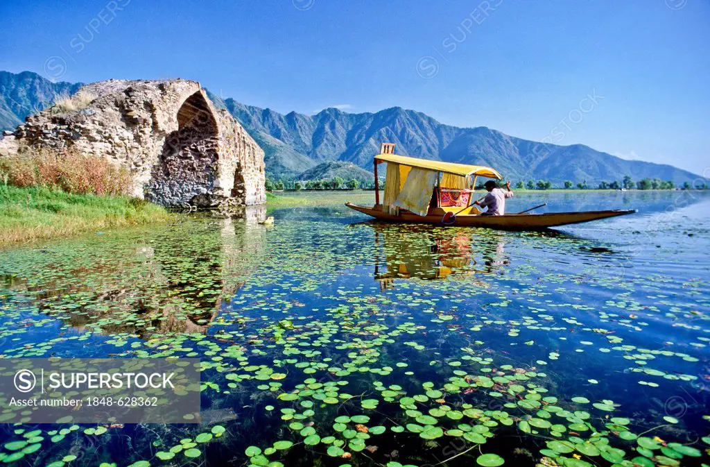 Ruined bridge and shikara boat on Dal Lake, Srinagar, Jammu and Kashmir, India, Asia