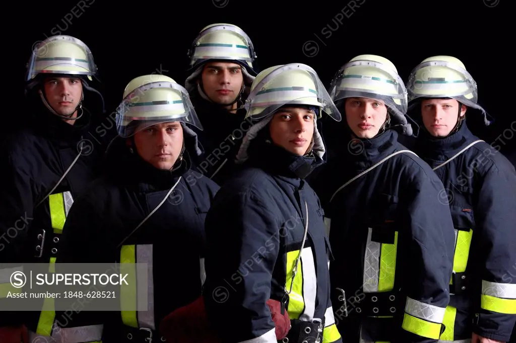 Firefighters wearing their uniforms for a response, protective clothing made of Nomex, a helmet with a visor, professional firefighters from the Beruf...