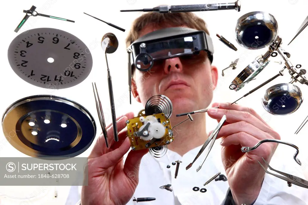 Precision mechanics, watchmaker repairing a clockwork, alarm clock, using a head-worn loupe system