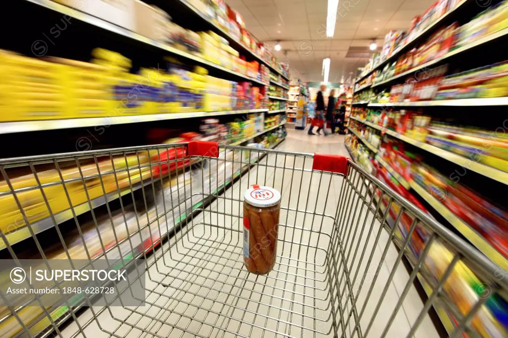 Shopping trolley being pushed through a corridor, food section, supermarket, Germany, Europe