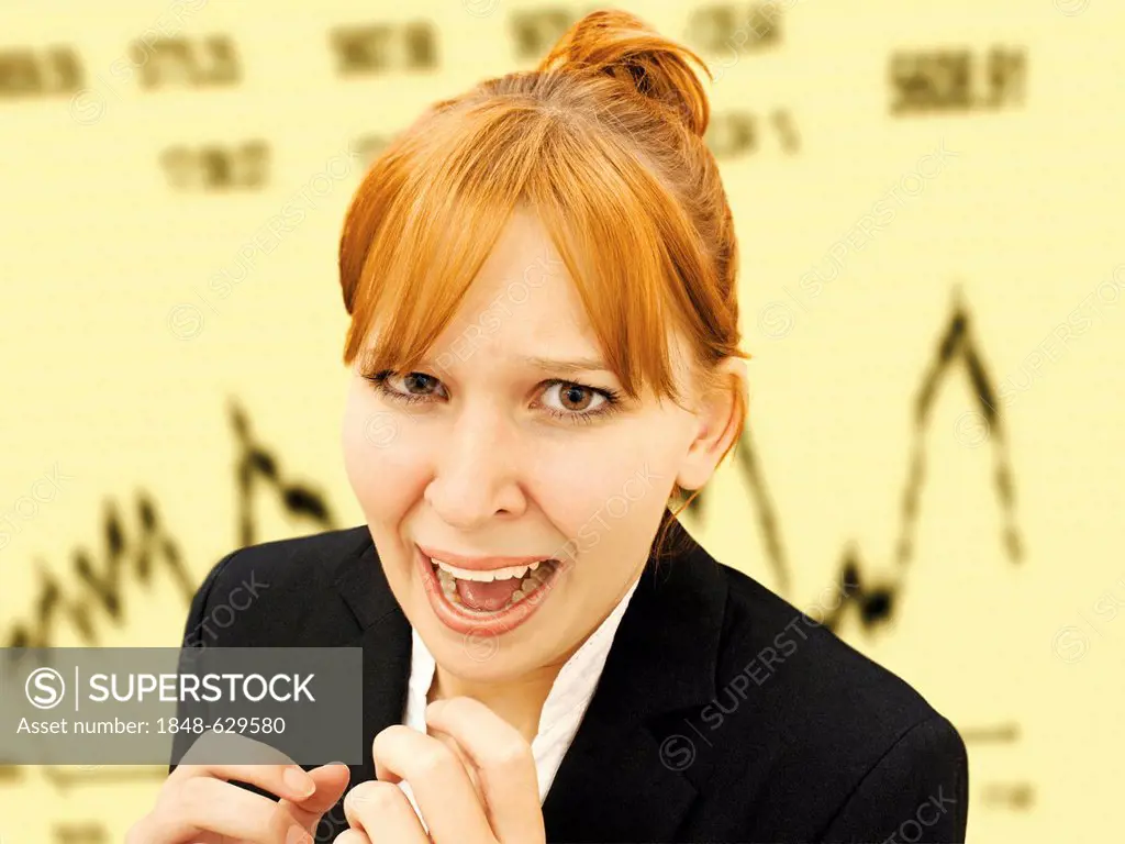 Portrait of an excited, hysterical businesswoman standing in front of a stock market index