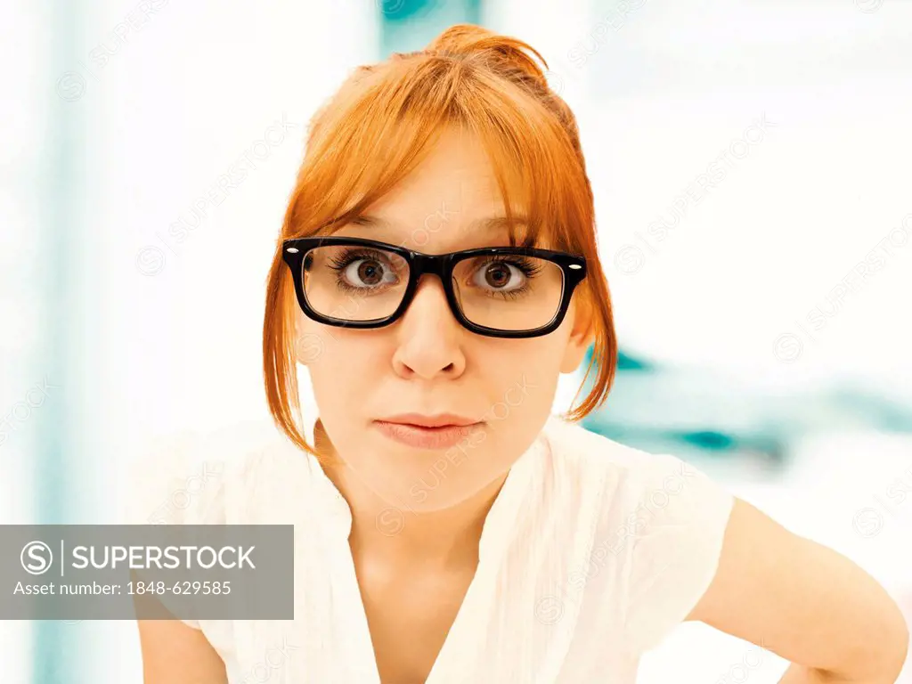 Portrait of a surprised young businesswoman with glasses