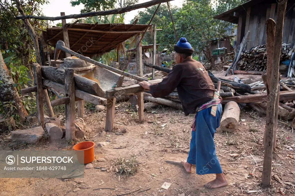 Husband working on a corn mill, village of hill tribe people, Hmong people, northern Thailand, Thailand, Asia