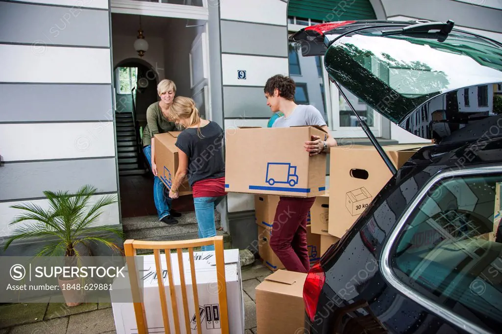 Private relocation, friends helping to unload a car