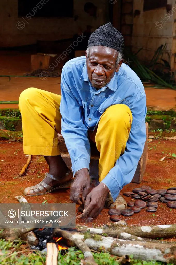 Man making traditional foot and hand rattles, Juju Rattles from Uyot, Bafut, Cameroon, Africa