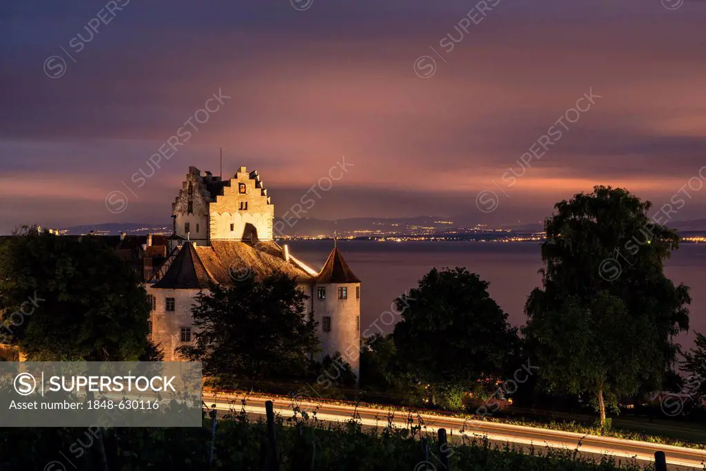 Night view of the historic Burg Meersburg Castle on the shore of Lake Constance, the Swiss shore at back on the horizon, Lake Constance region, Baden-...