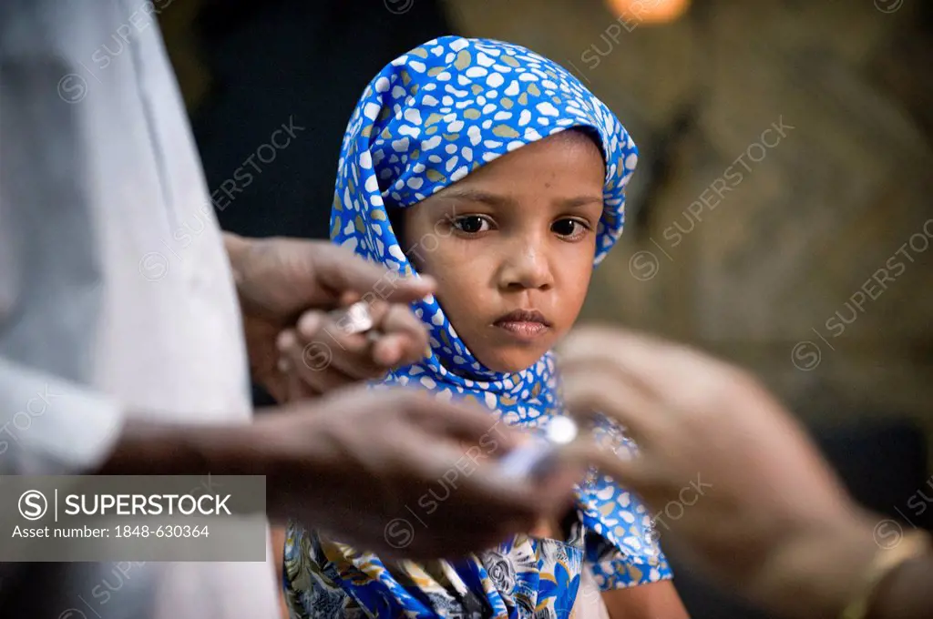 Girl watching preparations for a vaccinations, clinic of the aid organisation Aerzte fuer die Dritte Welt, German for Doctors for the Third World, Ger...
