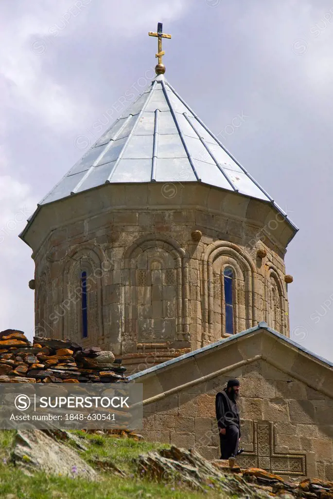 The famous Gergeti Trinity Church or Tsminda Sameba at the Chechen border, Stepantsminda, Georgia, Caucasus, Middle East