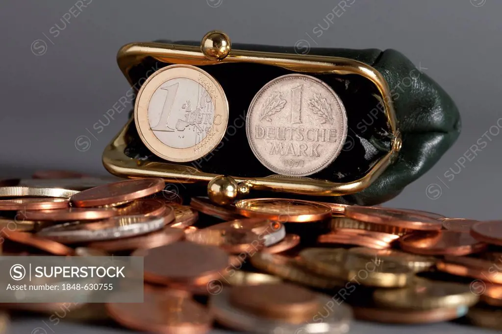 1 euro coin and 1 Deutsche Mark, German mark coin, in a purse
