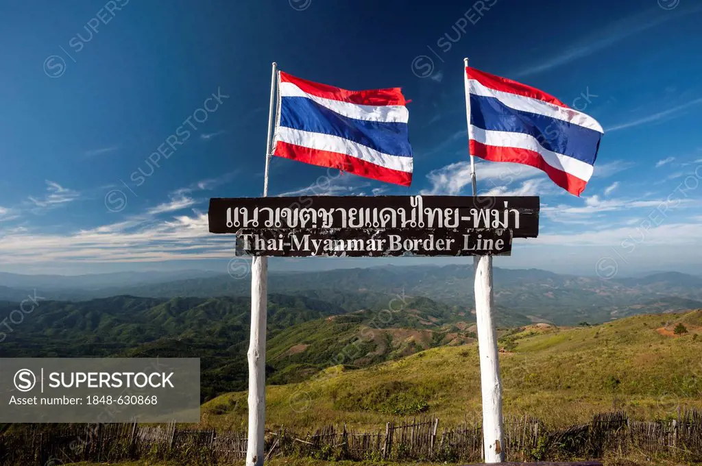 Thai national flags and a sign, border between Thailand and Burma, or Myanmar, northern Thailand, Thailand, Asia