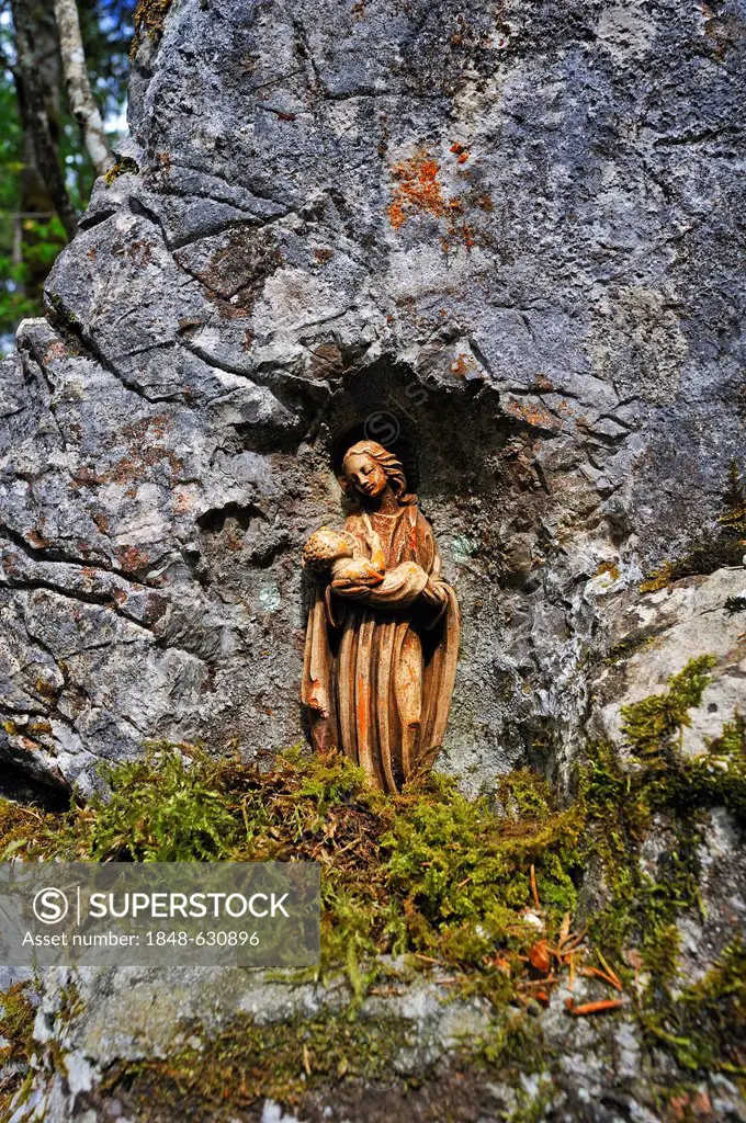 Little statue of Mary on a rock on the hiking trail between Hintersee and Ramsau, Upper Bavaria, Germany, Europe