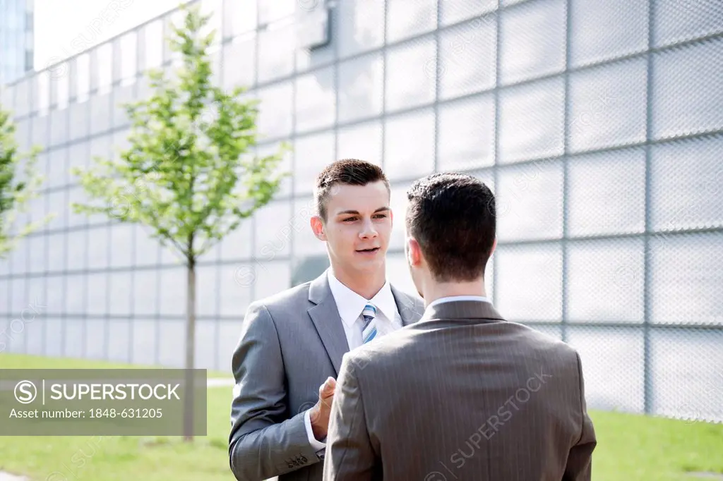 Young businessman talking to a colleague