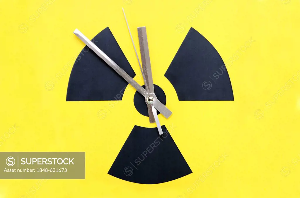 Atomic symbol with clock hands set at 11:55, symbolic image for to phase-out nuclear power