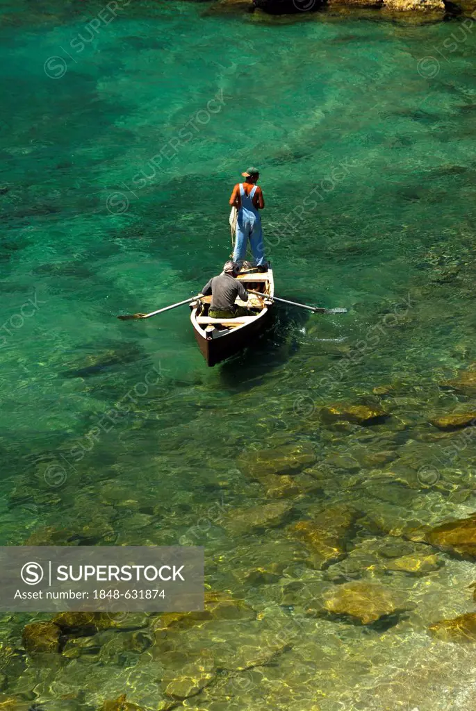 Man doing traditional net fishing in crystal clear water, Trinidad, Cuba, Caribbean