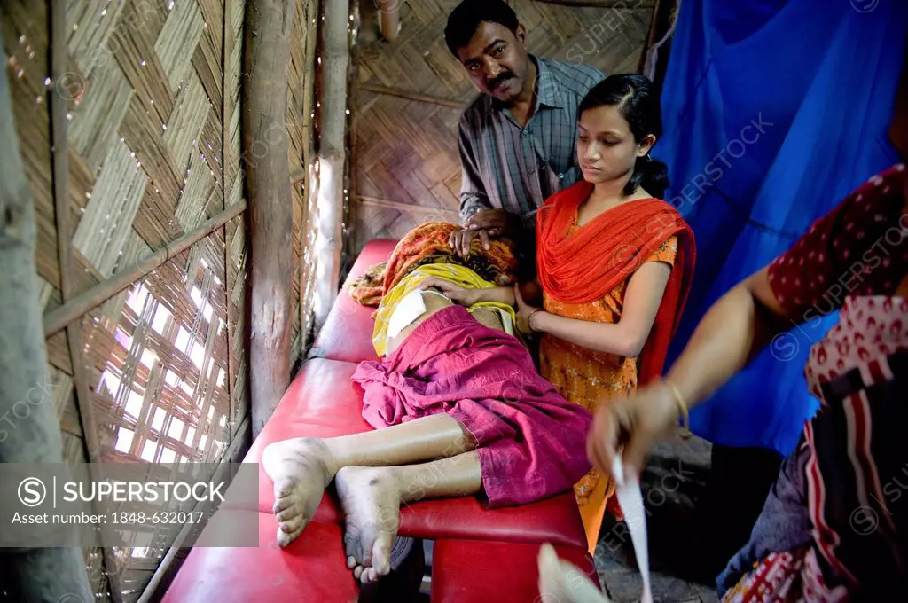 Patient lying on a trolley or gurney, clinic set up in a bamboo hut by the aid organisation Aerzte fuer die Dritte Welt, German for Doctors for the Th...