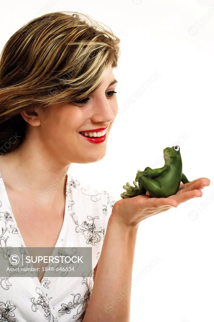 Young woman holding a green frog in her hand