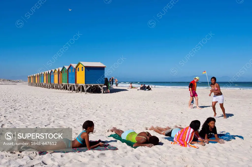 Young people sunbathing on the beach of Muizenberg, Western Cape, South Africa