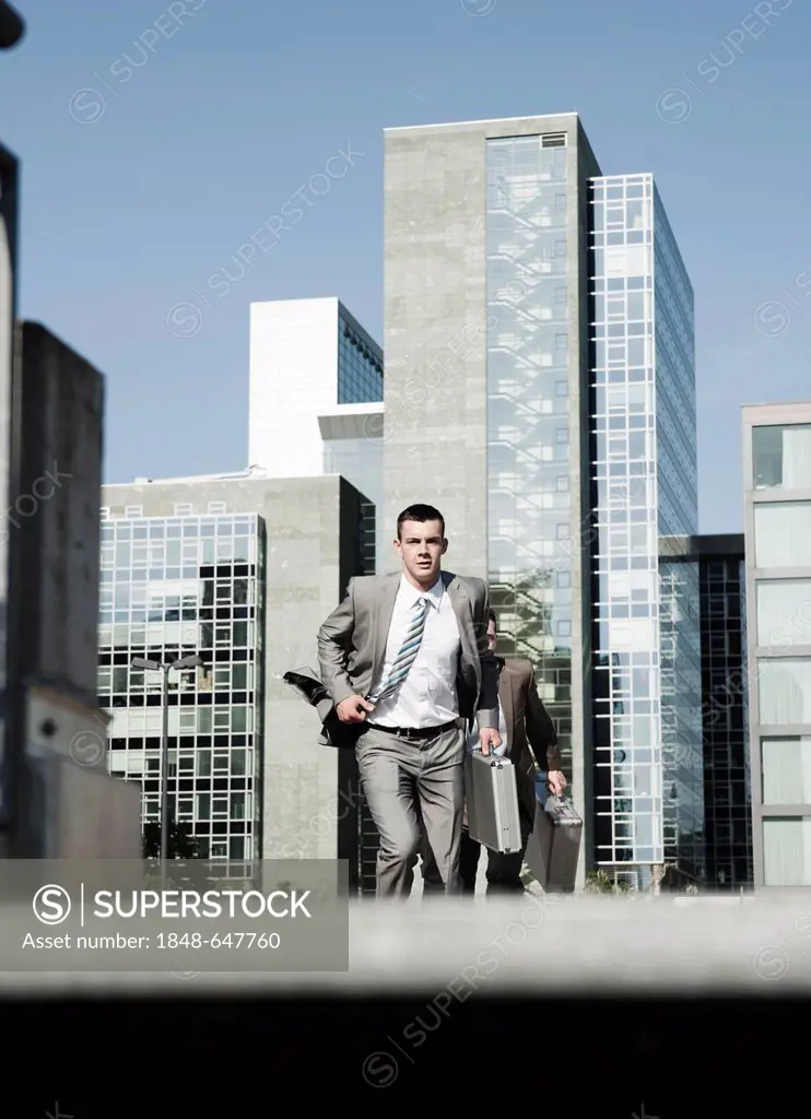 Two businessmen hurrying to an appointment