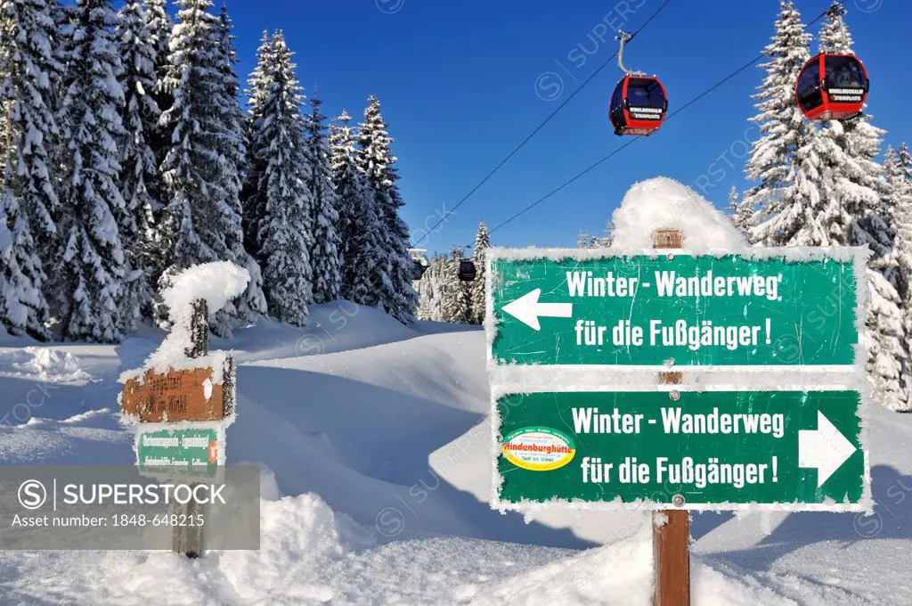 Signpost winter hiking trails, gondola lift or cable car, Winklmoos-Alm skiing area, Chiemgau region, Bavaria, Germany, Europe