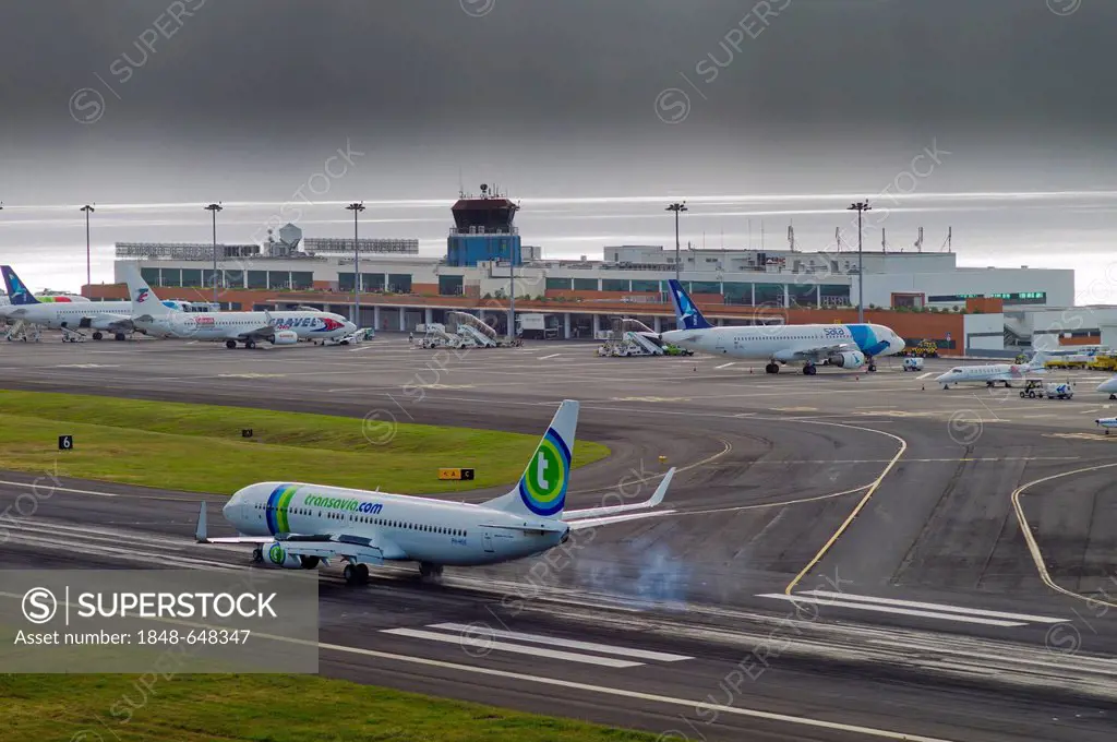 Landing approach of passenger plane of Transavia Airlines at the airport of Madeira during bad weather, LPMA, Funchal Airport or Airport Santa Catarin...