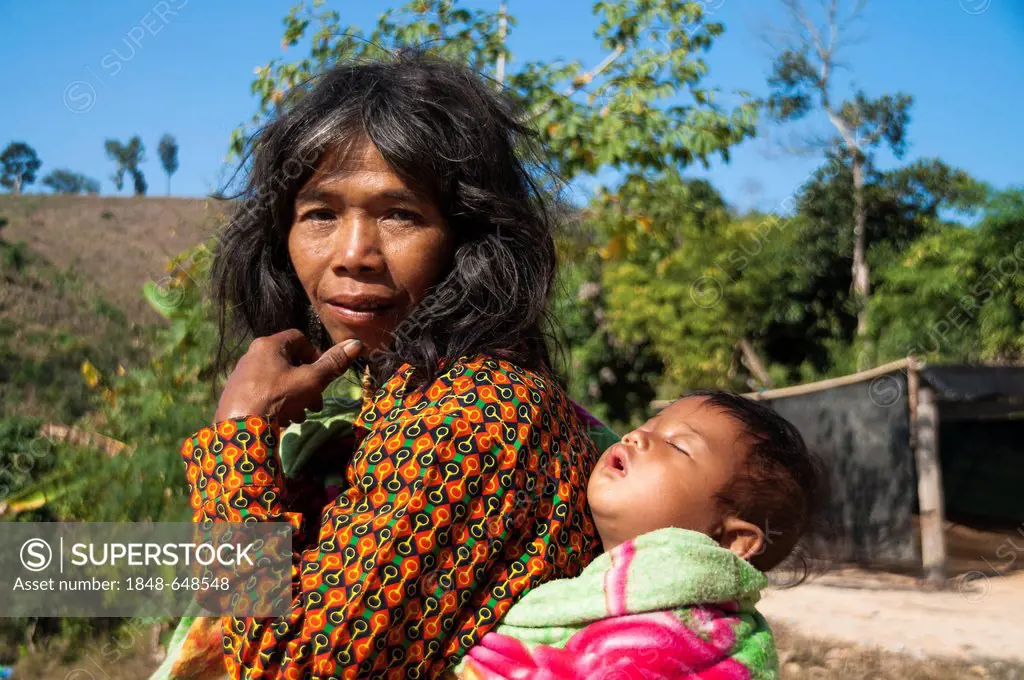 Woman dressed with modern clothing with a child from the Mlabri, Mrabri, Yumbri, Ma Ku or Spirits of the Yellow Leaves hill tribe, ethnic minority, no...