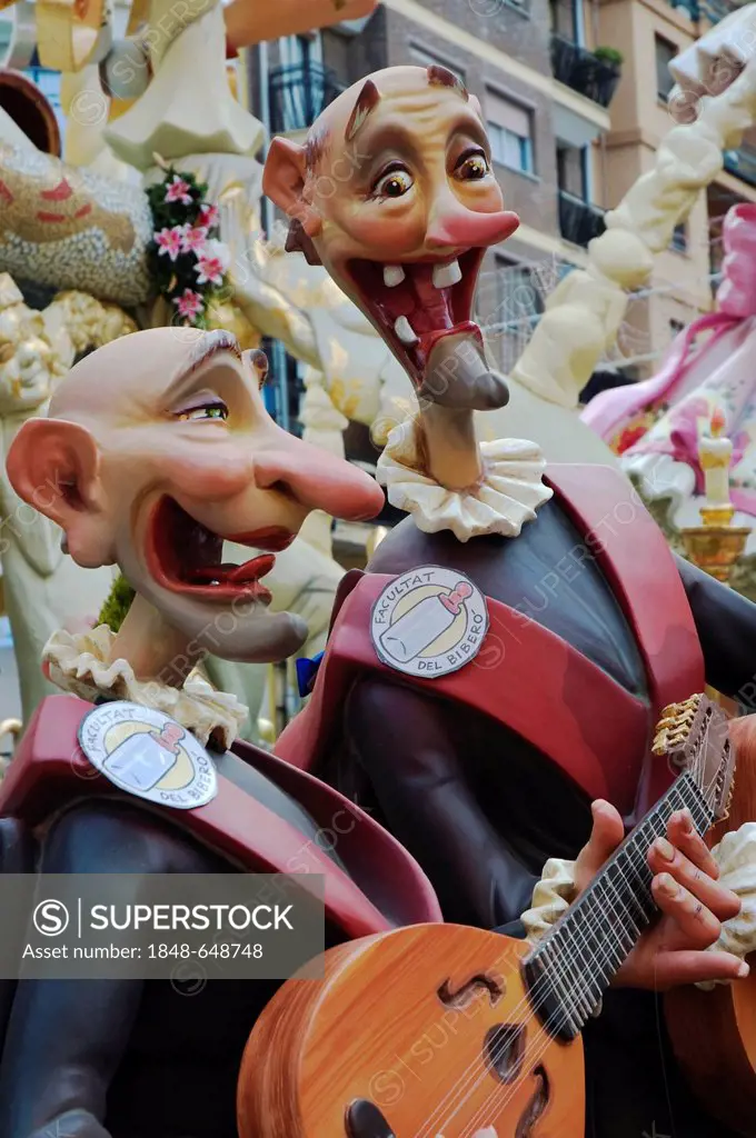 Gap-toothed musicians wearing uniforms, sculptures of the Faculty of Drinkers at a parade, Fallas festival, Falles festival in Valencia in early sprin...