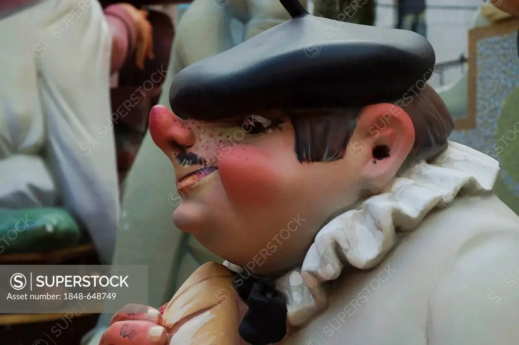 Basque man with a stuck-up nose wearing a beret, crude carnival characters and satirical sculptures at a parade, Fallas festival, Falles festival in V...