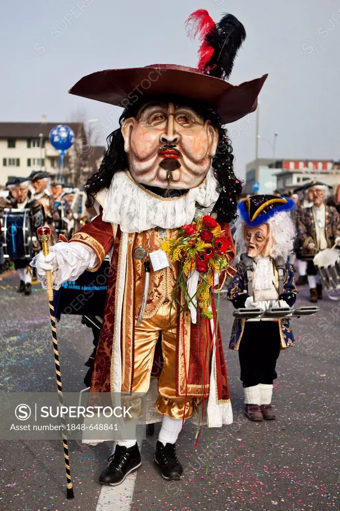 Guggenmusik Loechlitramper Littau music group dressed to the theme of 40 years of carnival battle during the carnival procession, Littau, Lucerne, Swi...