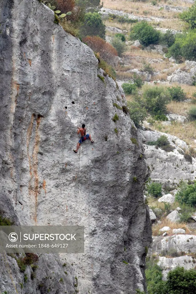 Climber, UNESCO world heritage site of the Sicel necropolis of Pantalica, situated in the Monti Iblei between Ferla and Sortino, Sicily, Italy, Europe