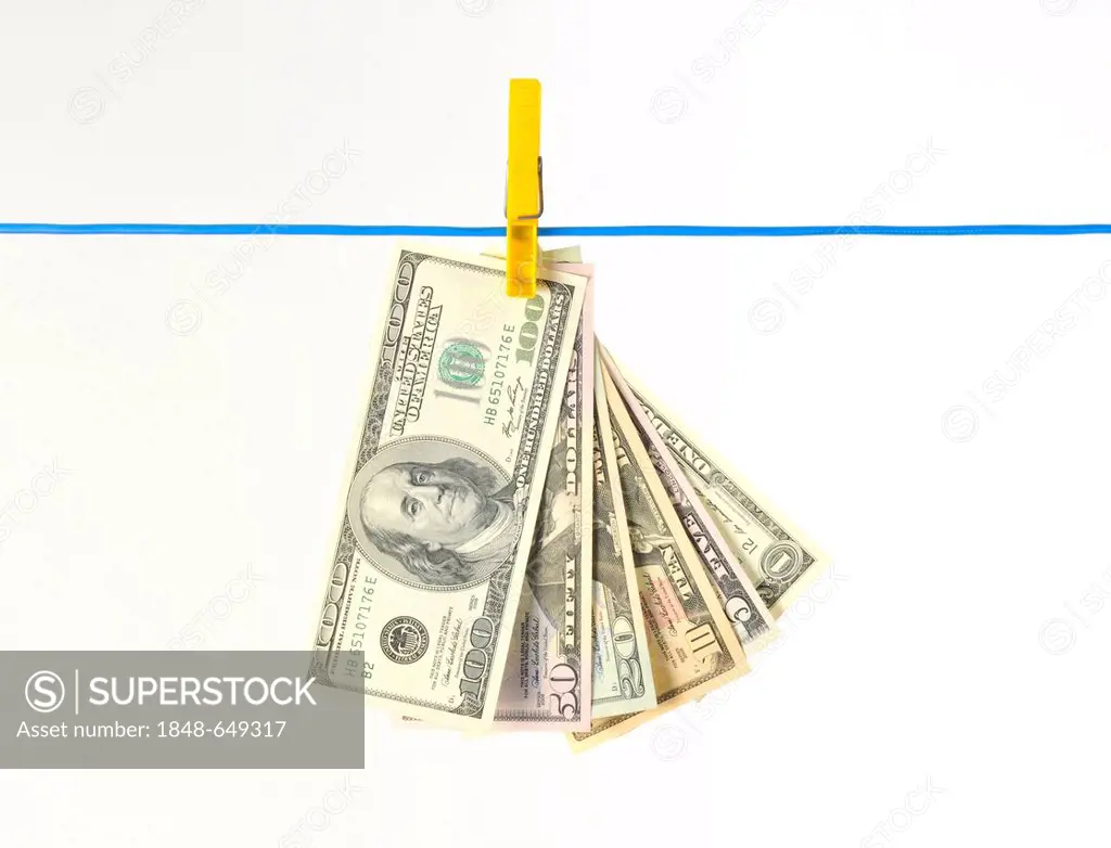 Fan of U.S. dollar banknotes hanging on a clothesline, symbolic image for money laundering, illegal money