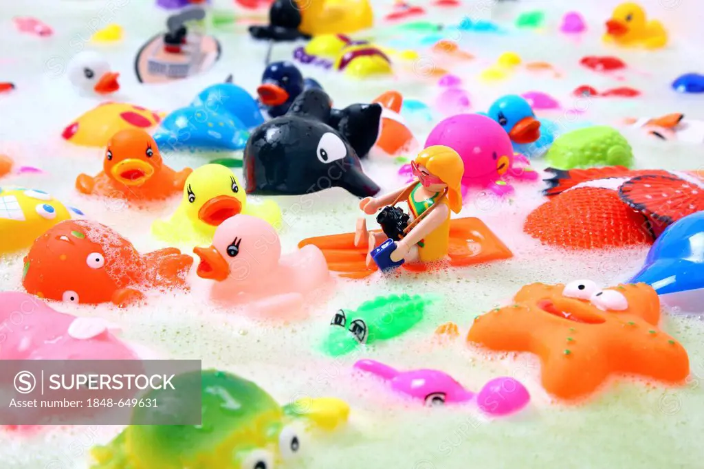 Various colourful water toys with bath foam