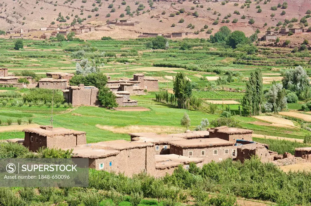 River valley with fields and a small Berber village in the High Atlas Mountains, adobe buildings, Ait Bouguemez Valley, High Atlas Mountains, Morocco,...