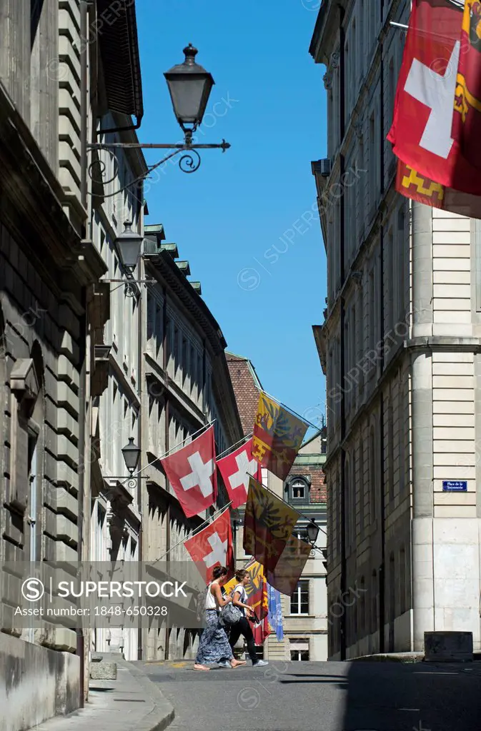 Flags of Switzerland and the Canton of Geneva in the Rathausgasse lane or Rue de l'Hôtel de Ville, in the old town of Geneva, Switzerland, Europe