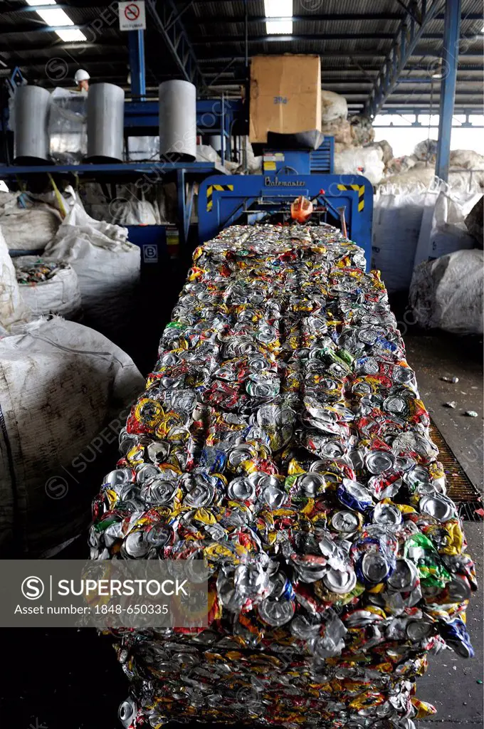Cans made of tinplate, aluminium are pressed into blocks in a recycling plant, for the export to China, San José, Costa Rica, Latin America, Central A...