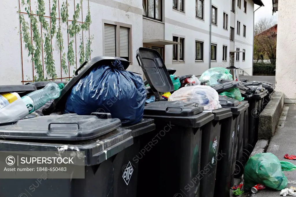 A line of rubbish bins outside a block of flats, Prien, Chiemgau, Upper Bavaria, Germany, Europe